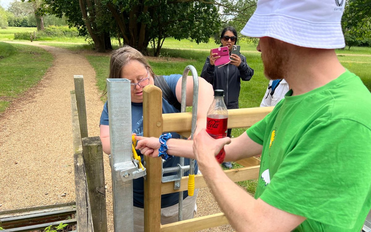 People opening a gate in a park