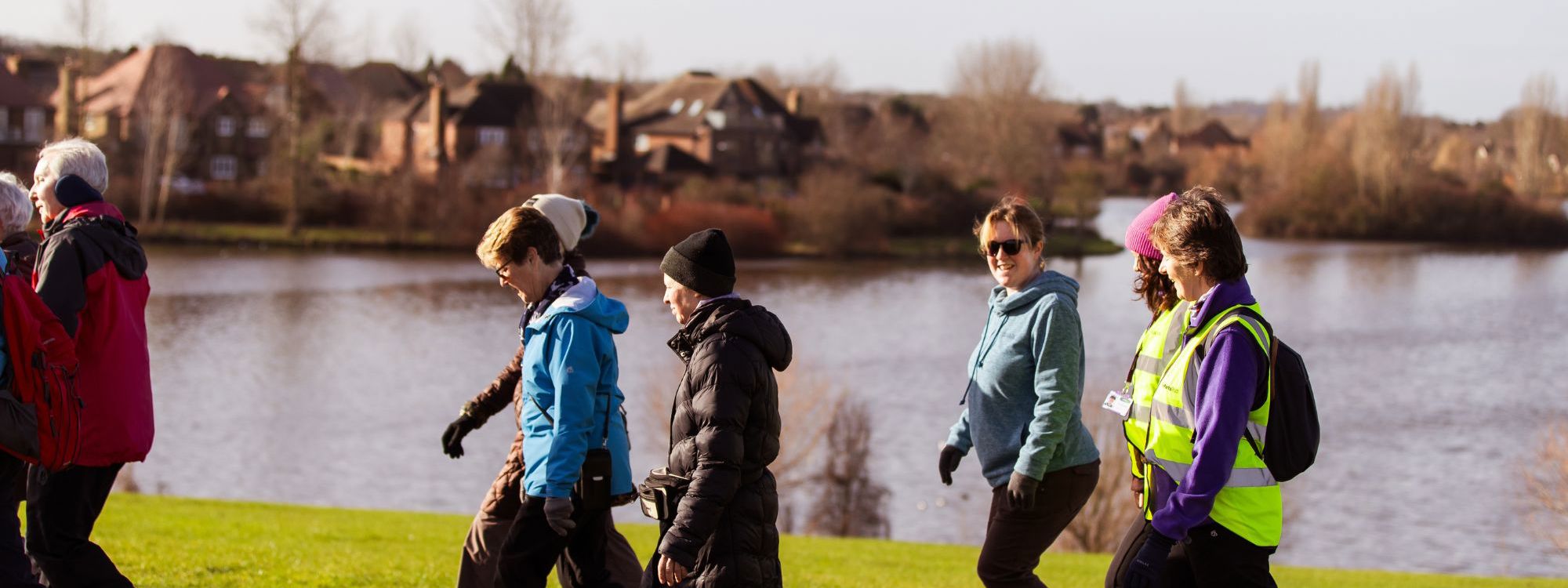 Group walking past Furzton Lake in Milton Keynes