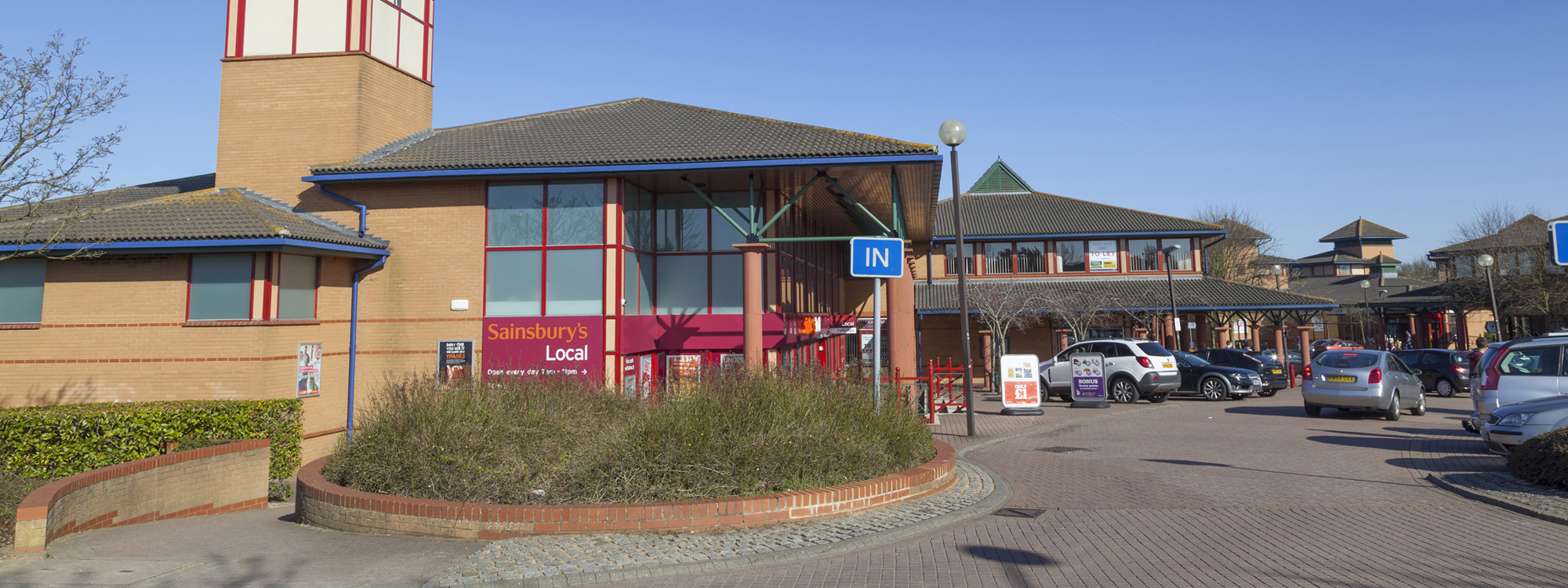 view of the entrance to the local centre shops with iconic clock tower