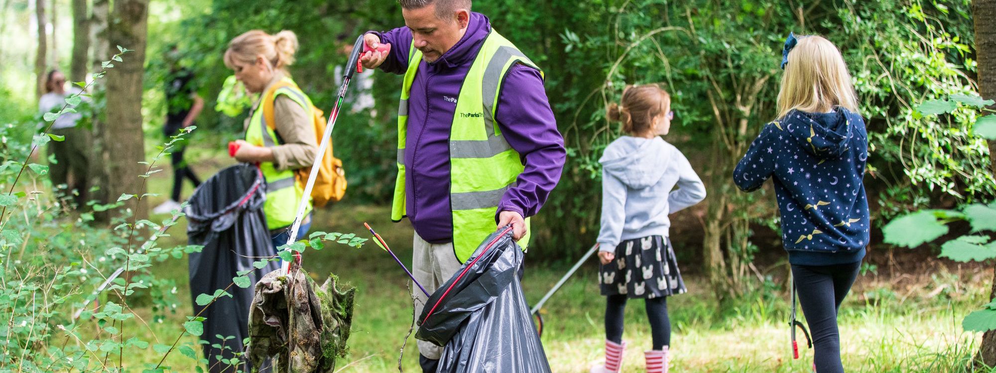 Ranger picking up litter in the park