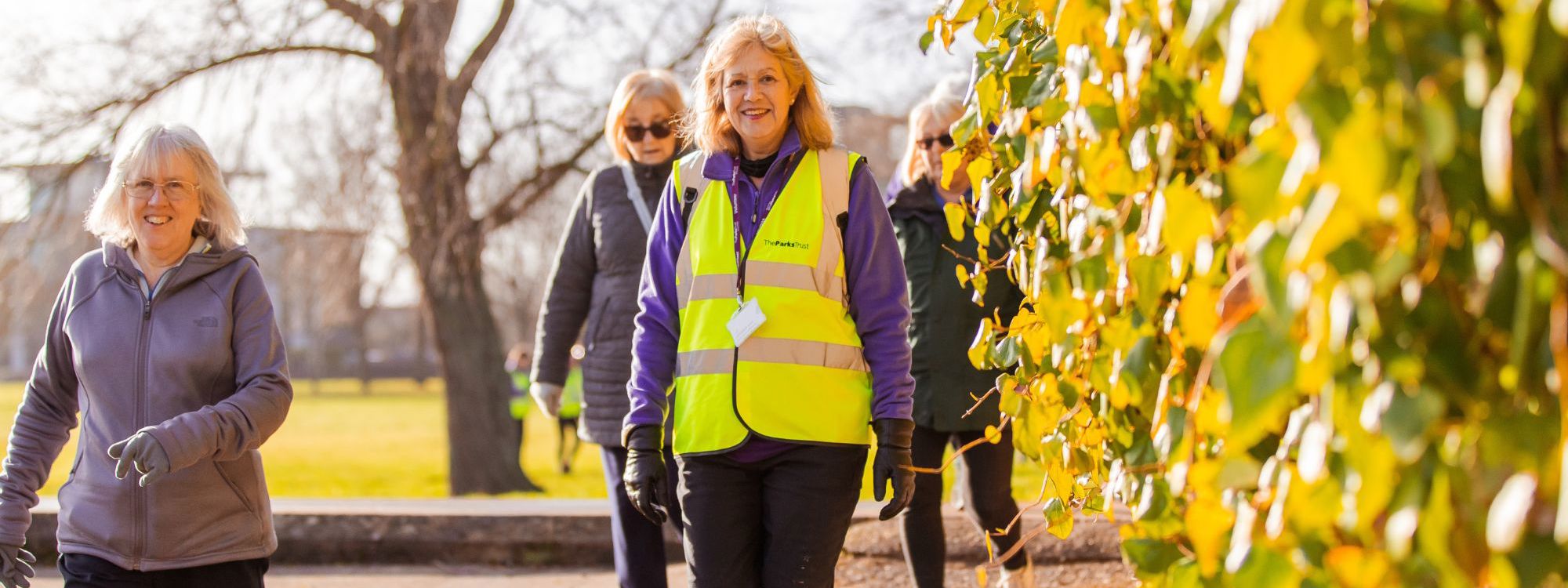 Women smiling at walking event in the park