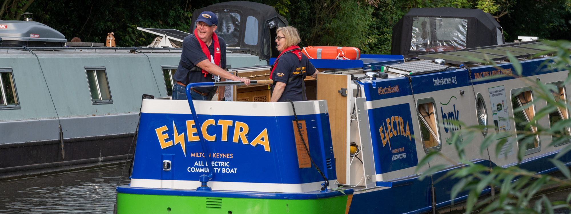 People standing at the back on a canal boat