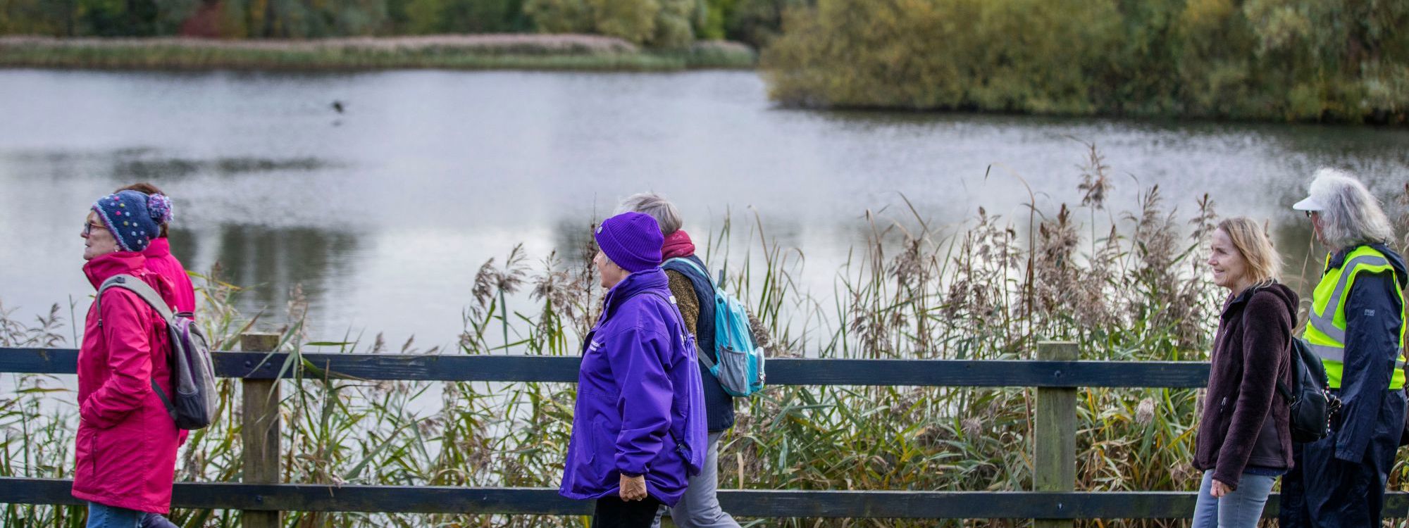 Women walking past Caldecotte Lake in Milton Keynes