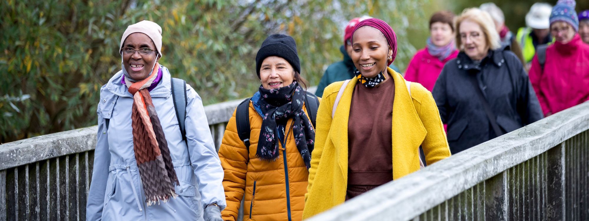 Group of people walking across a bridge