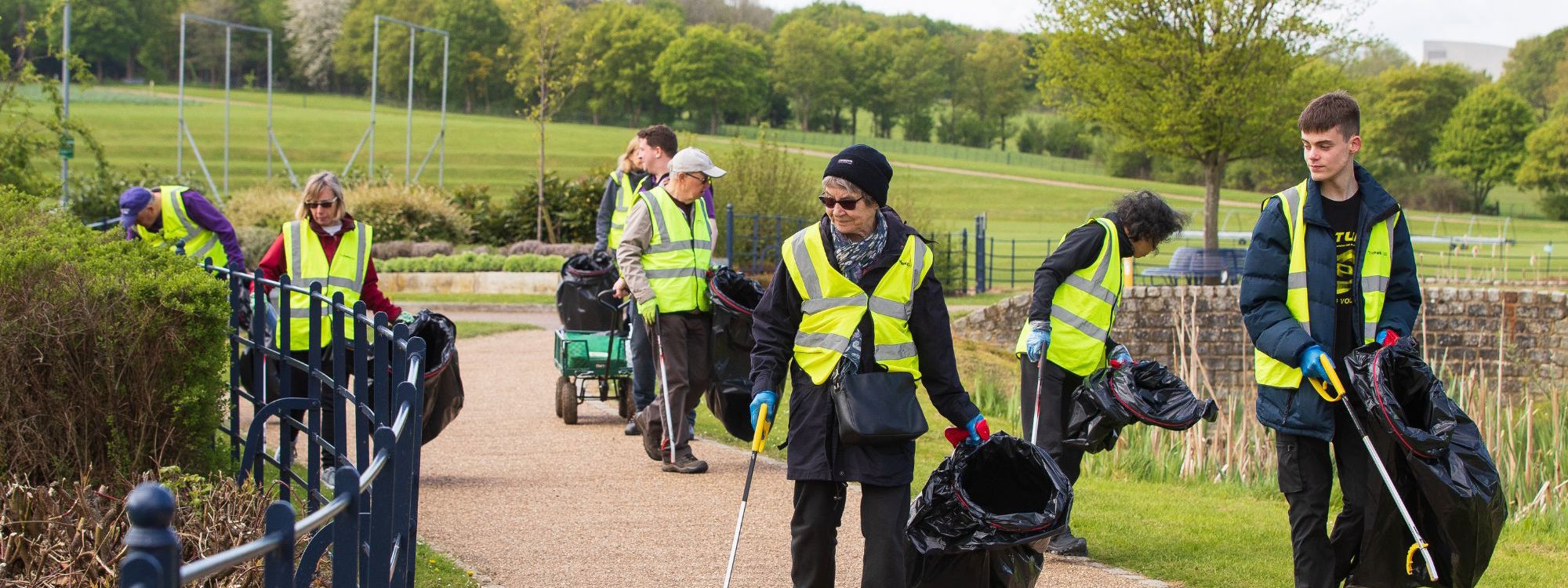 Group of people litter picking along a path in Campbell Park