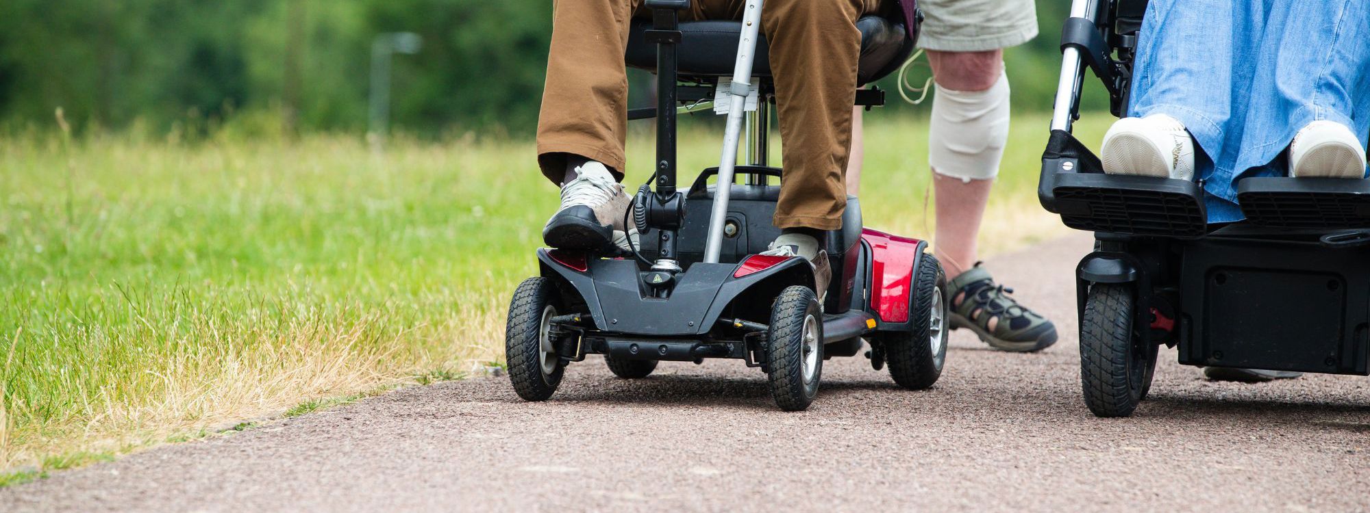 People walking and moving with motorised wheelchair and scooter