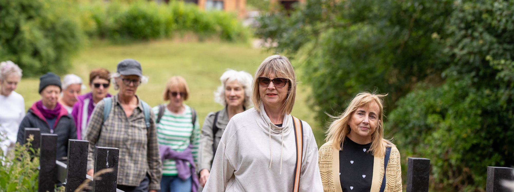 Group of women walking through parkland