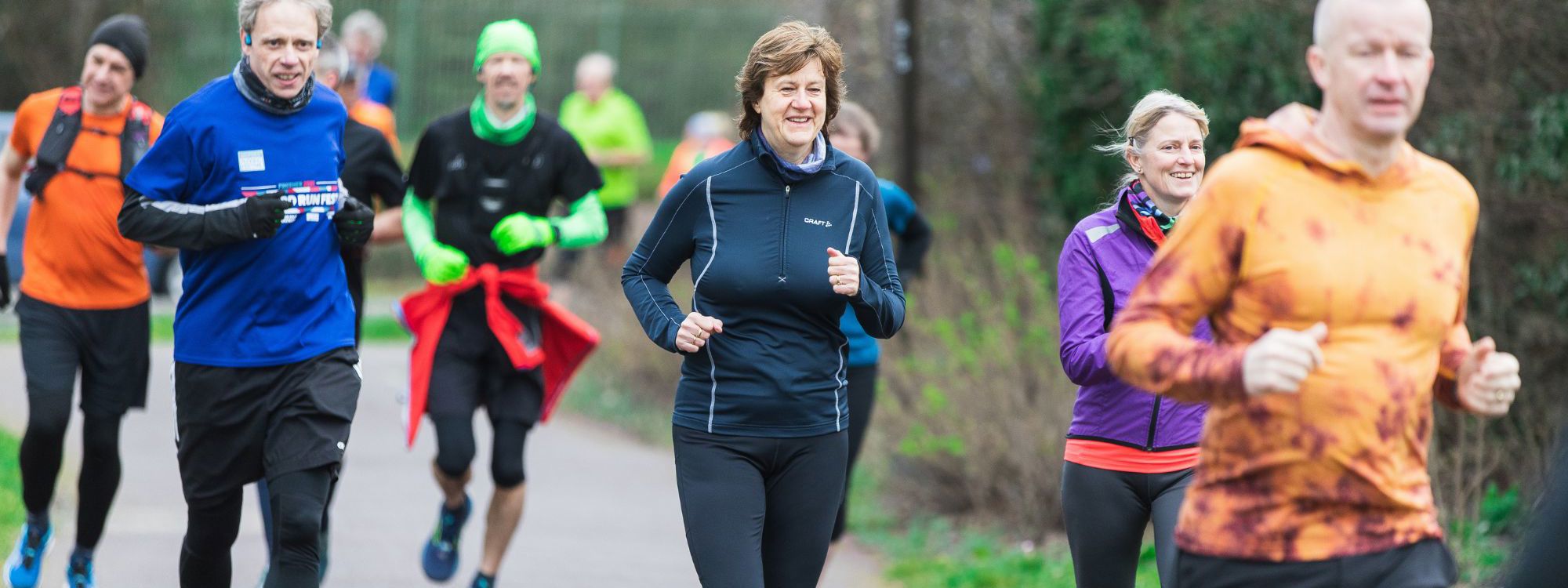 Group of people running in park at an event in Milton Keynes