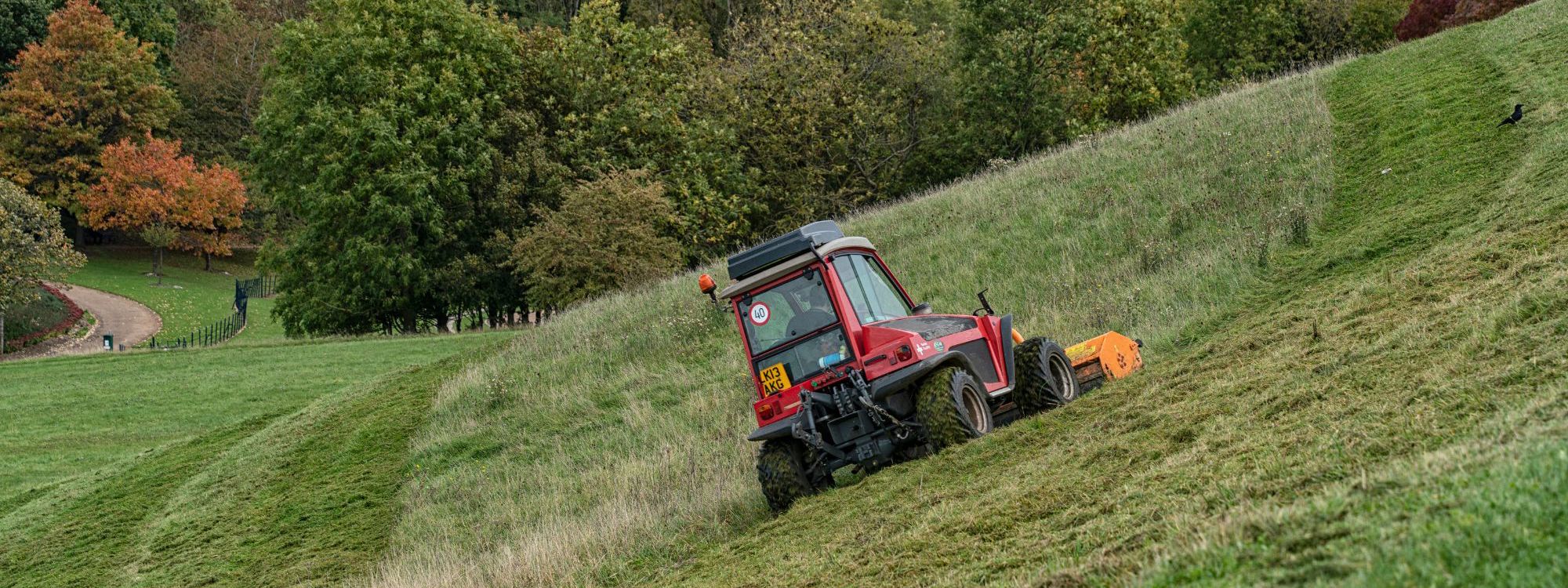 Contractor carrying out grass cutting work in Campbell Park Milton Keynes