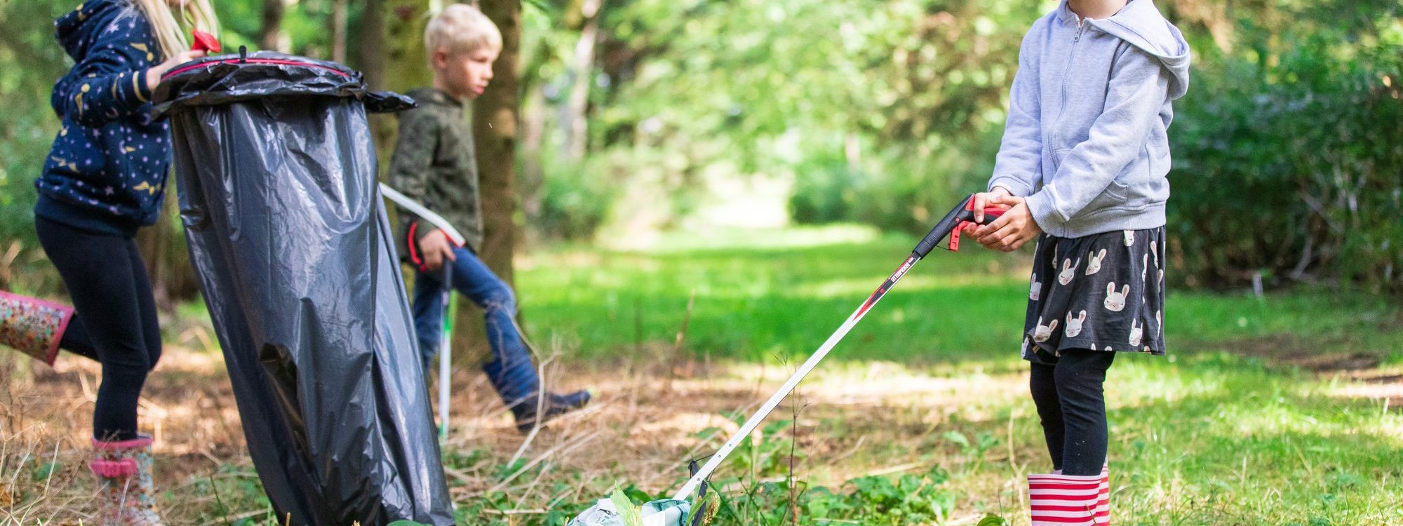 Children picking up litter from parkland