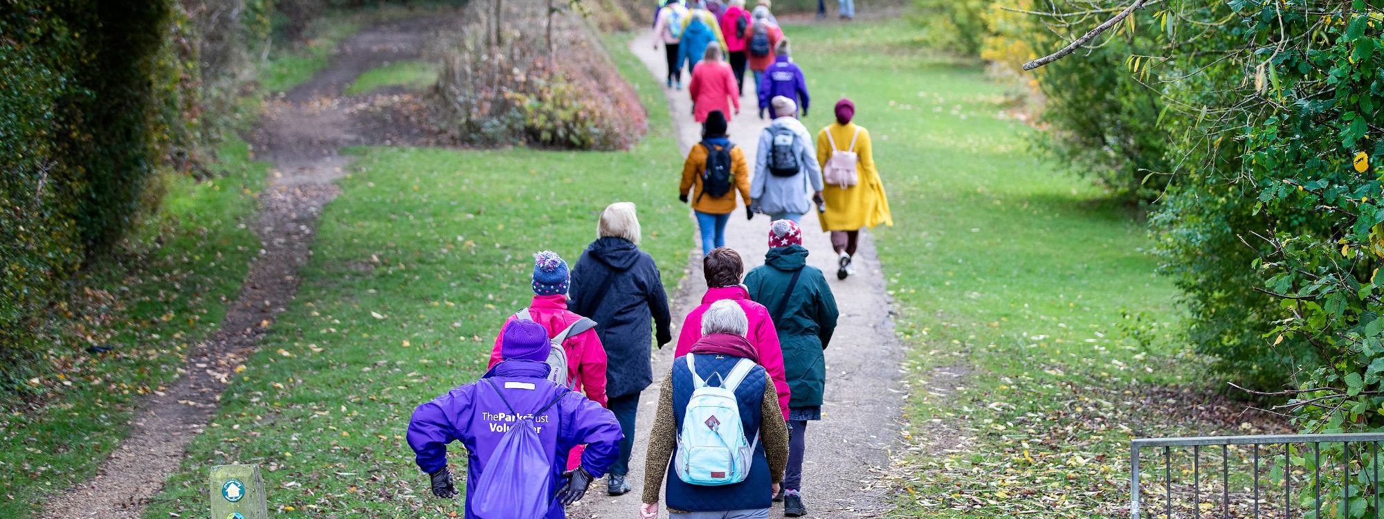 Group of people walking through park in Milton Keynes