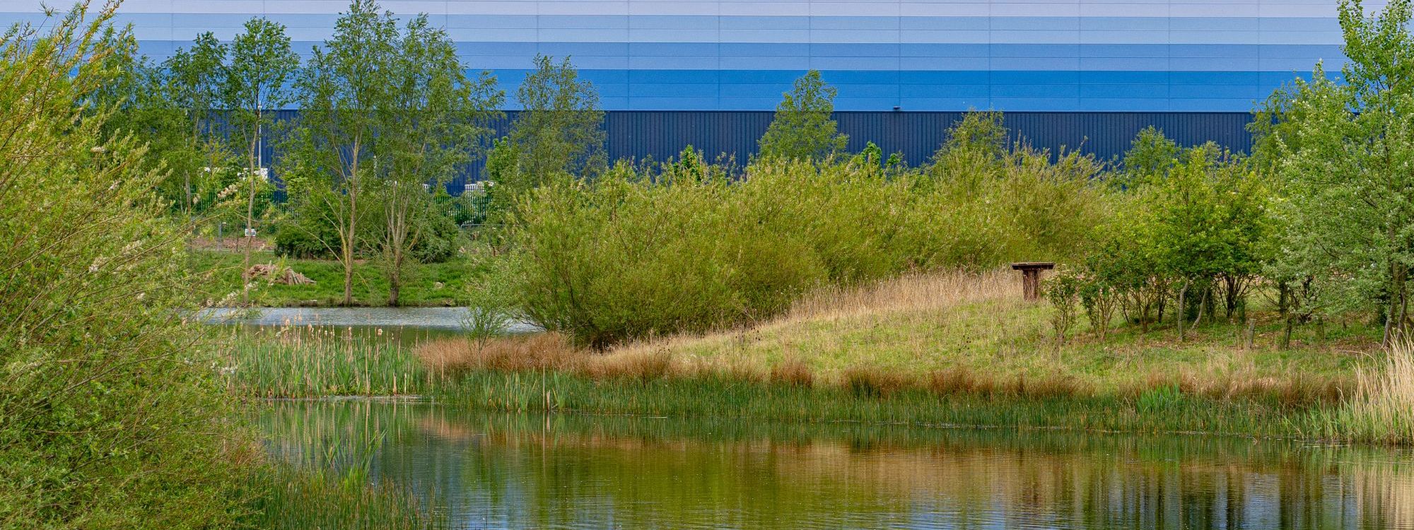 Lake with warehouse in the background at Magna Park in Milton Keynes