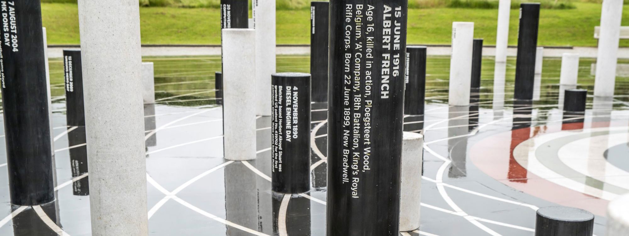 Black pillar inscribed with tribute to Albert French Day at the Milton Keynes Rose