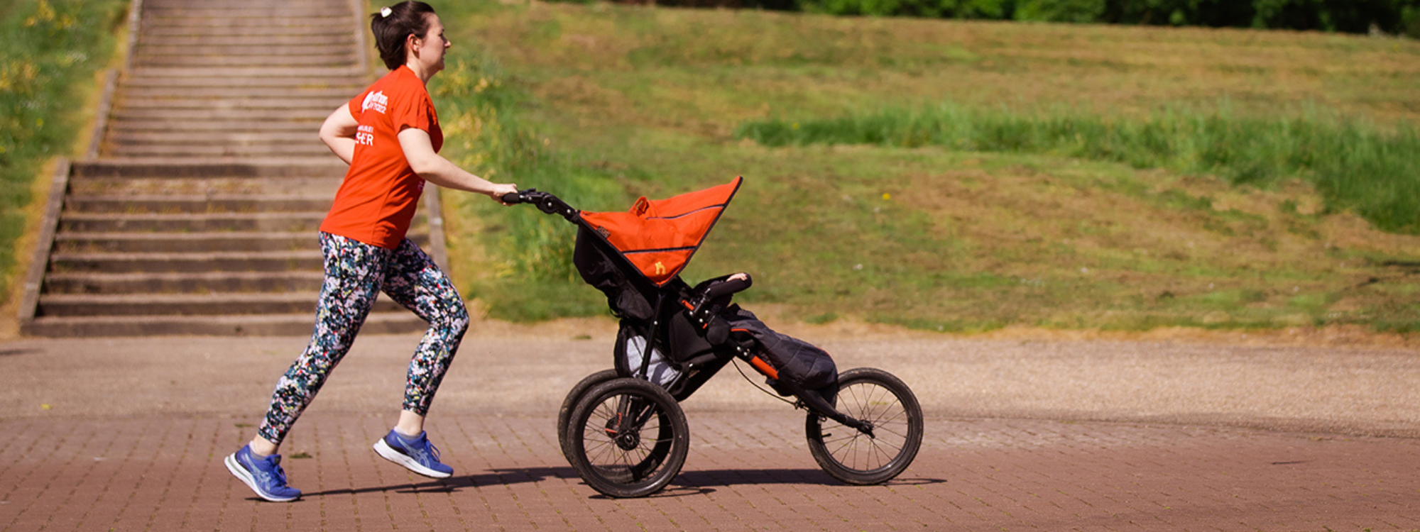 Person running with a pushchair along Redway by the Peace Pagoda