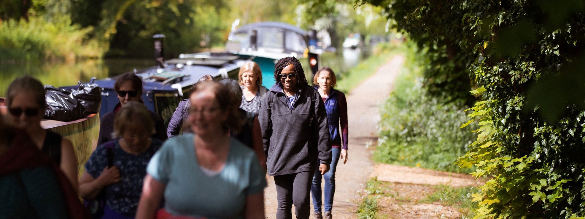 Women walking next to Grand Union Canal in Milton Keynes