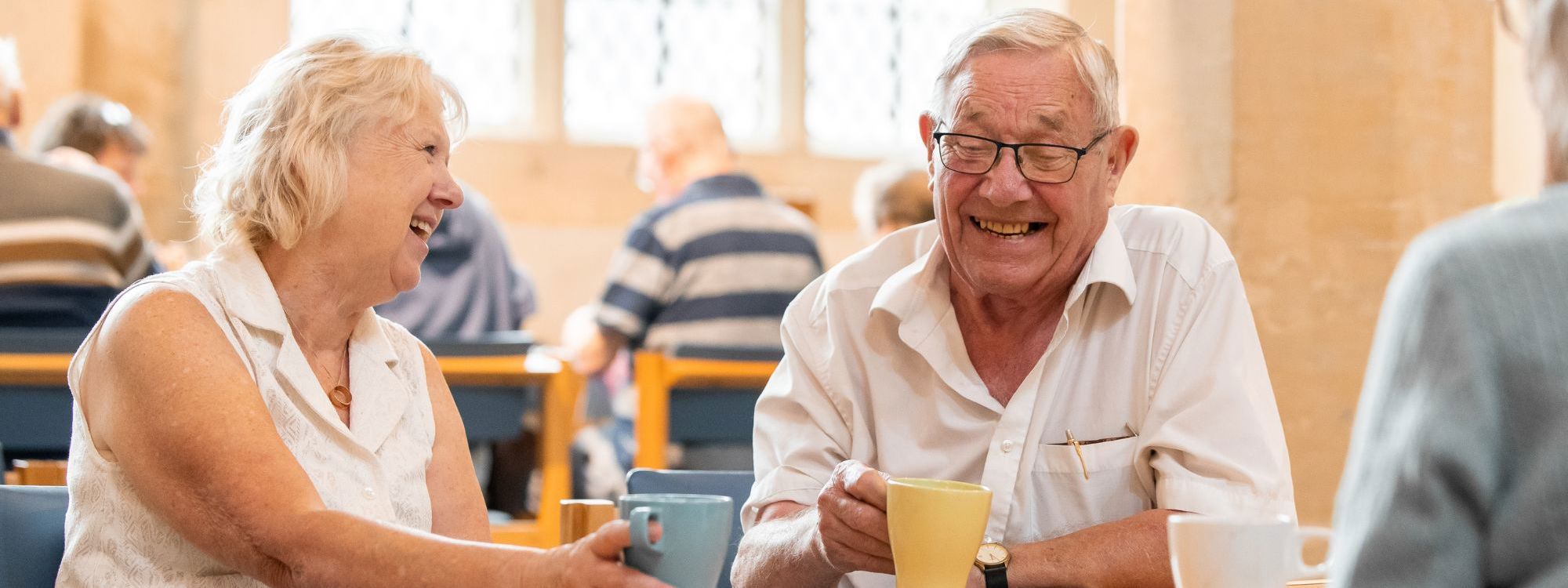 Two people sat drinking coffee inside church