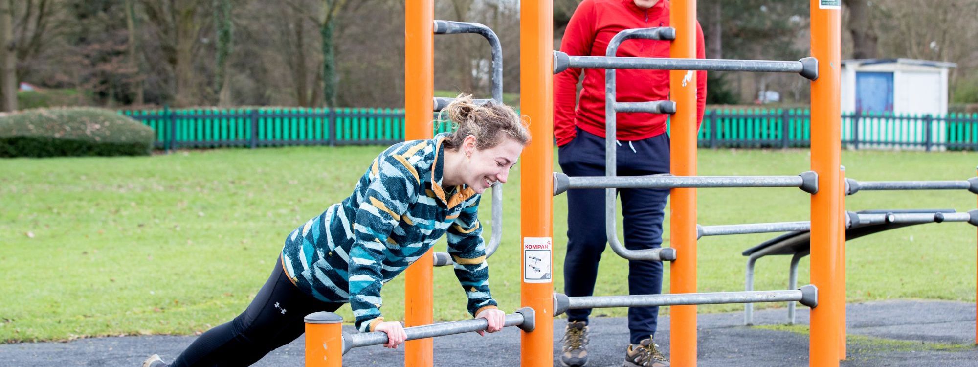 Person doing push ups on outdoor gym equipment at Willen Lake